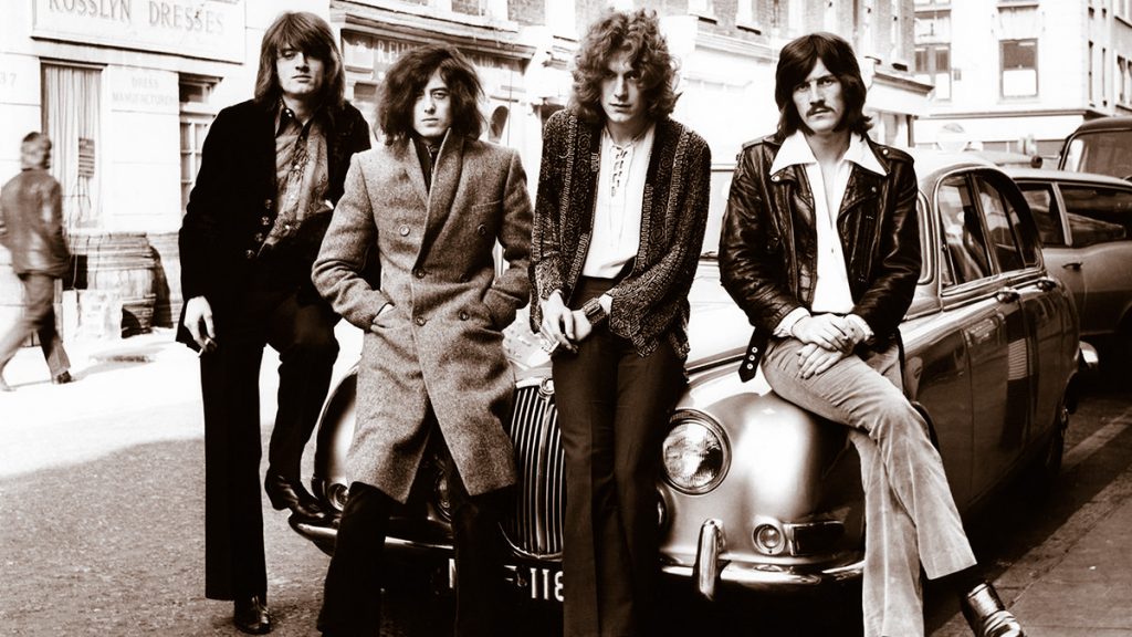 UNITED KINGDOM - DECEMBER 01:  Photo of LED ZEPPELIN and John Paul JONES and Jimmy PAGE and Robert PLANT and John BONHAM; Posed group portrait, sitting on car bonnet at their first photo shoot for WEA L-R John Paul Jones, Jimmy Page, Robert Plant and John Bonham in London in December 1968.  (Photo by Dick Barnatt/Redferns)